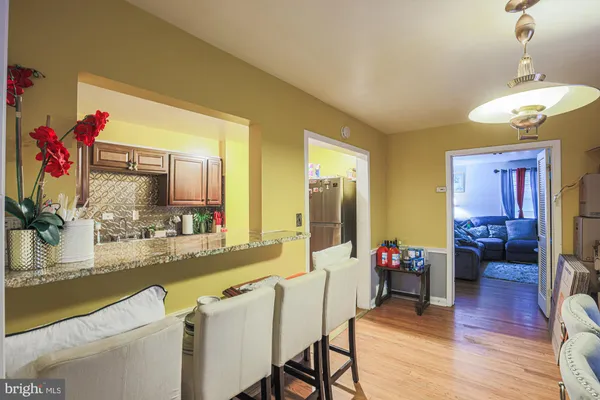 a dining room with furniture and wooden floor