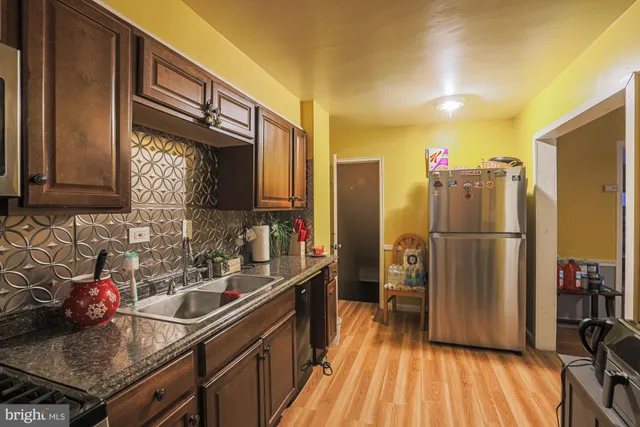 a kitchen with a sink stove and refrigerator