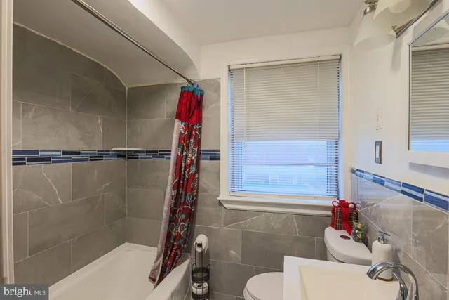 a bathroom with a shower and a sink