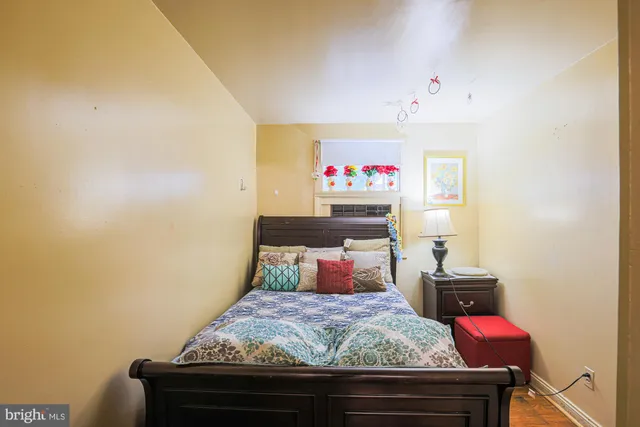 a living room with a bed and a dresser