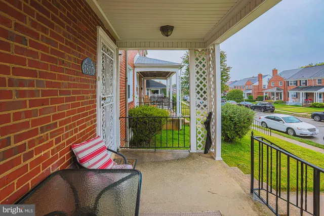 a brick building with a bench and a yard