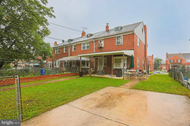 a front view of a house with swimming pool having outdoor seating