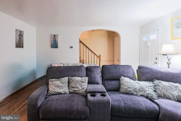 a living room with a couch and a wooden floor