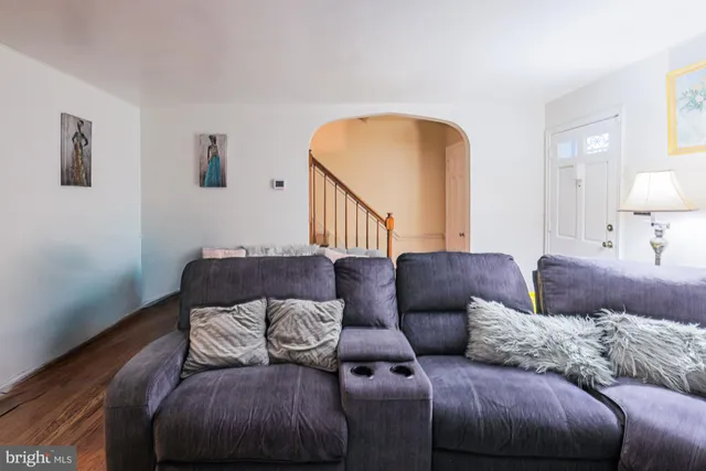 a living room with a couch and a wooden floor