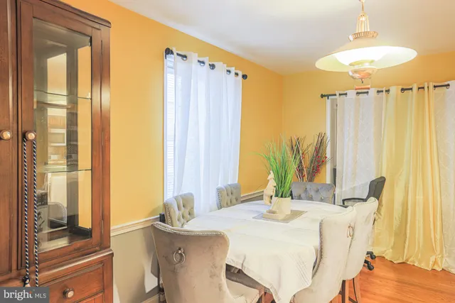 a dining room with a table and chairs
