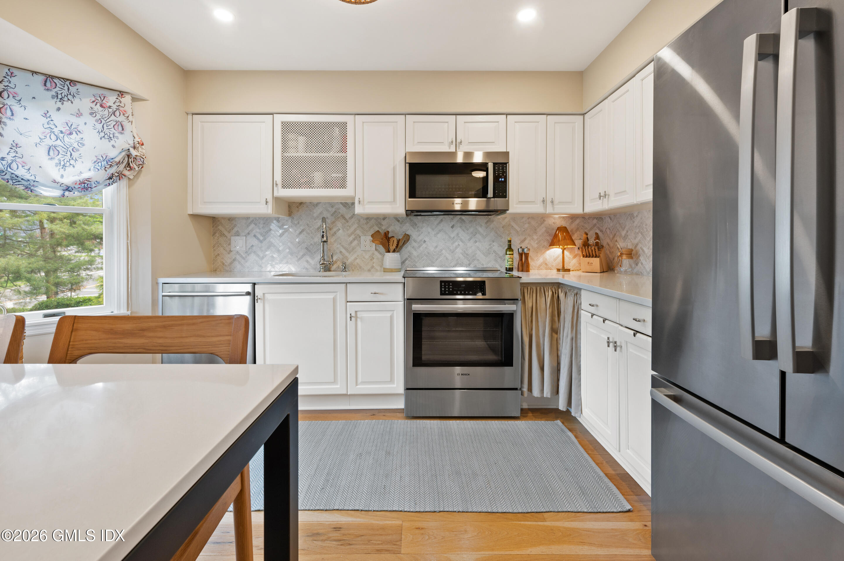 115 River Road, Unit 3 Cos Cob, CT 06807 - Photo 26 of 40 a kitchen with stainless steel appliances a stove a sink and a refrigerator