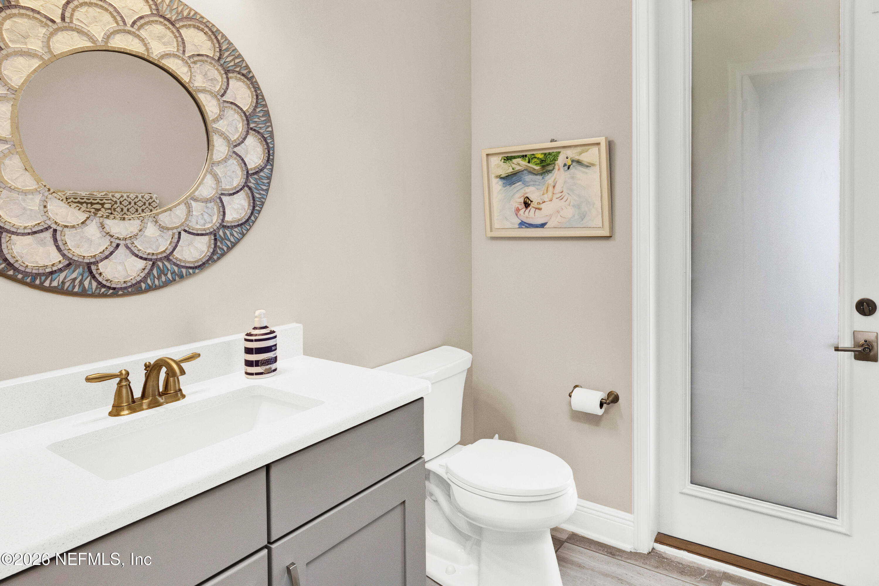 247 Rum Runner Way St. Johns, FL 32259 - Photo 14 of 42 a bathroom with a toilet a sink and a mirror