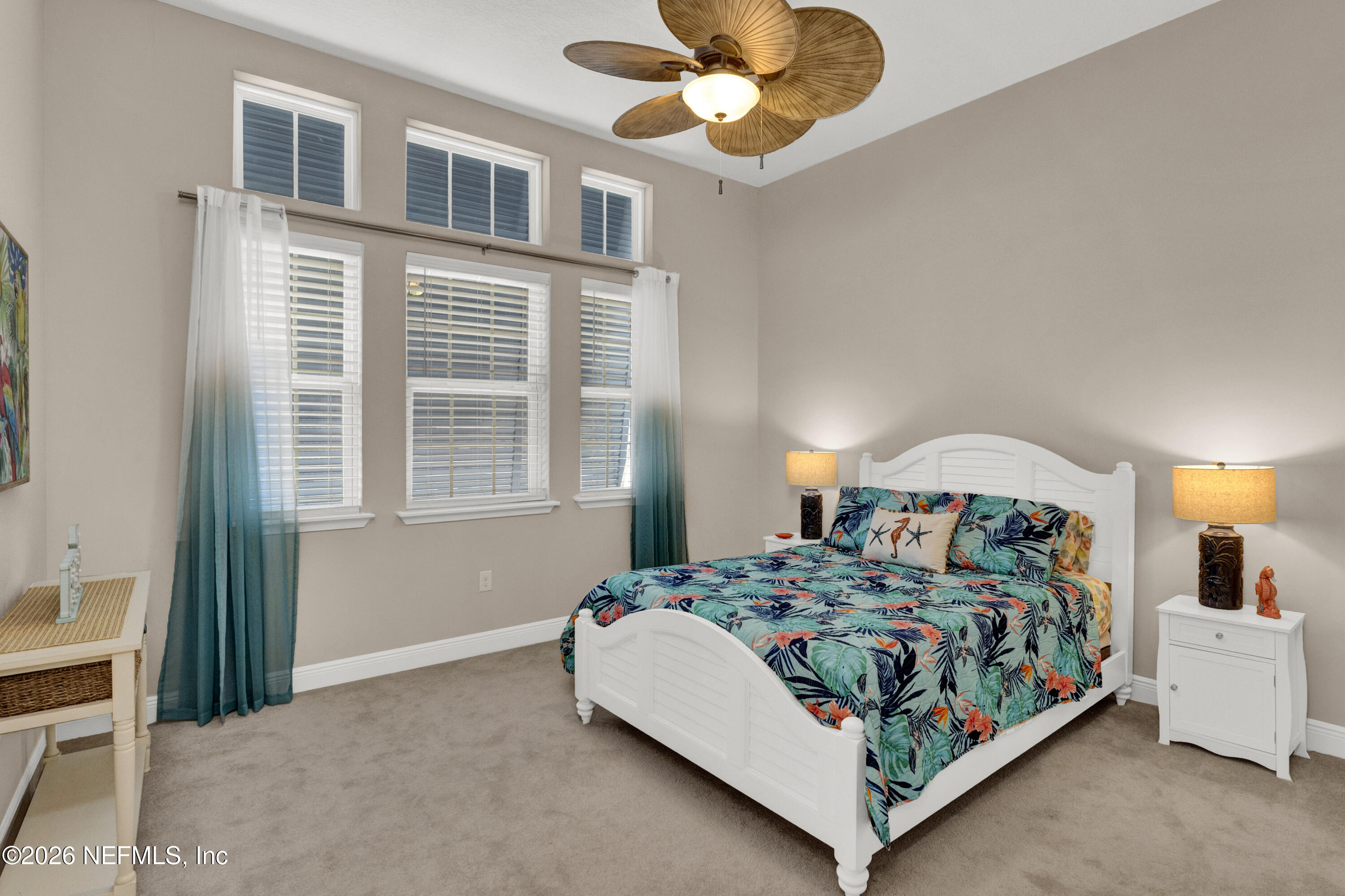 247 Rum Runner Way St. Johns, FL 32259 - Photo 23 of 42 a bedroom with a large bed and a chandelier