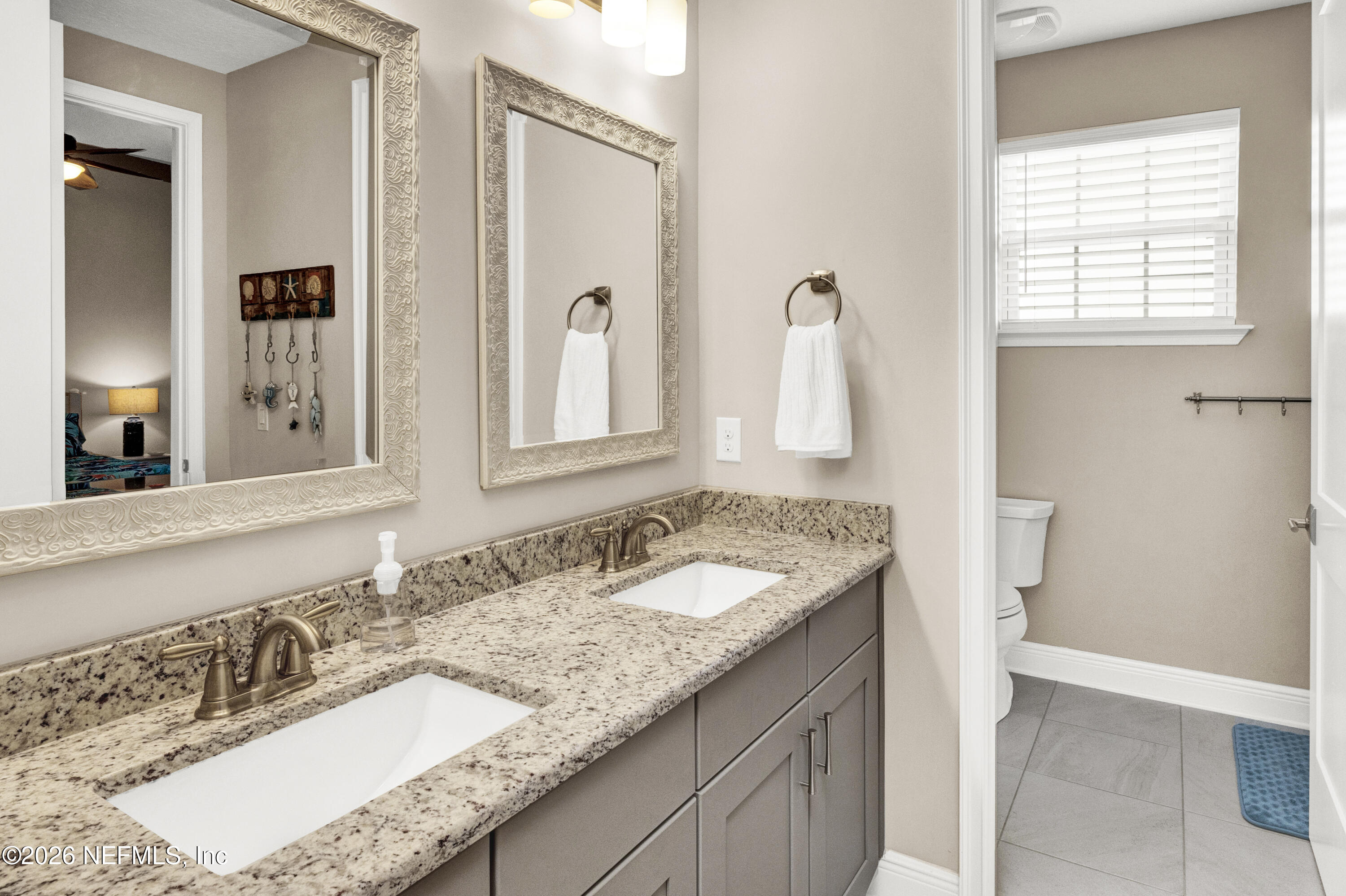 247 Rum Runner Way St. Johns, FL 32259 - Photo 24 of 42 a bathroom with a granite countertop sink and a mirror