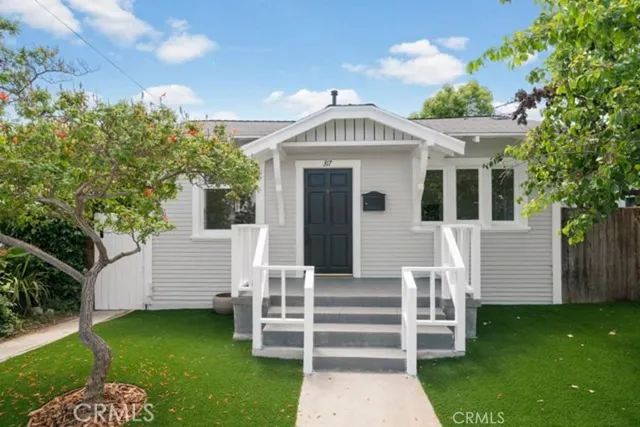 a front view of a house with a garden