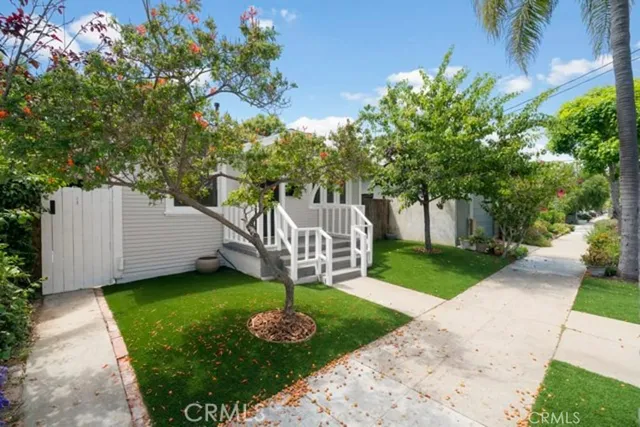 a view of a house with a yard and garden
