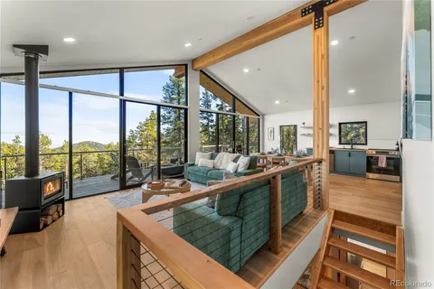 a living room with furniture and a floor to ceiling window