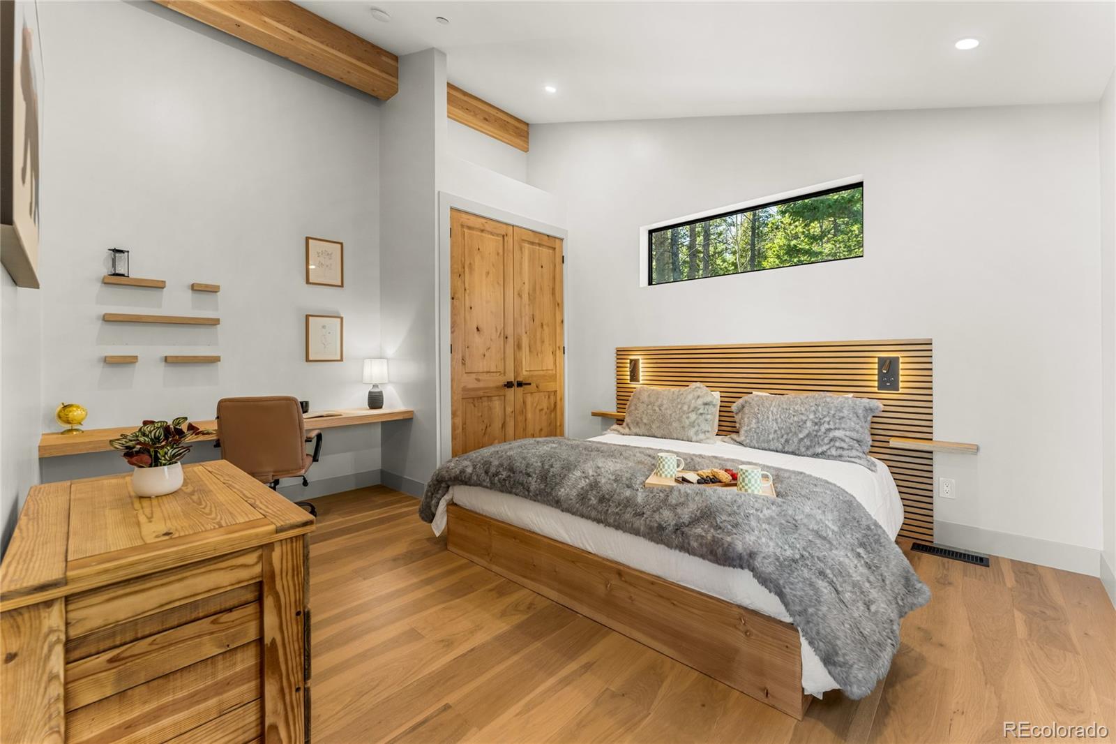 311 Pioneer Road Golden, CO 80403 - Photo 33 of 47 a bedroom with a bed and wooden floor