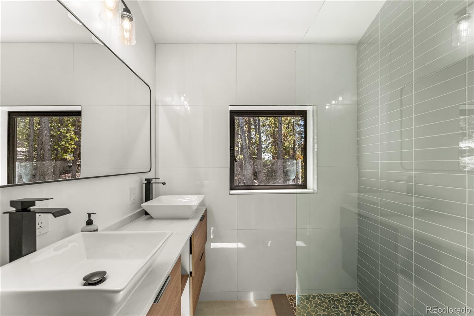 311 Pioneer Road Golden, CO 80403 - Photo 36 of 47 a bathroom with a sink a toilet and shower