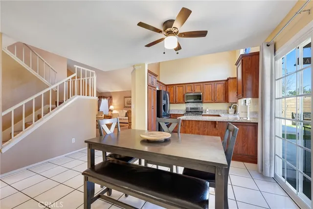 a kitchen with a table chairs refrigerator and cabinets