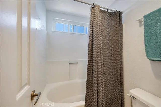 a bathroom with a shower and a toilet