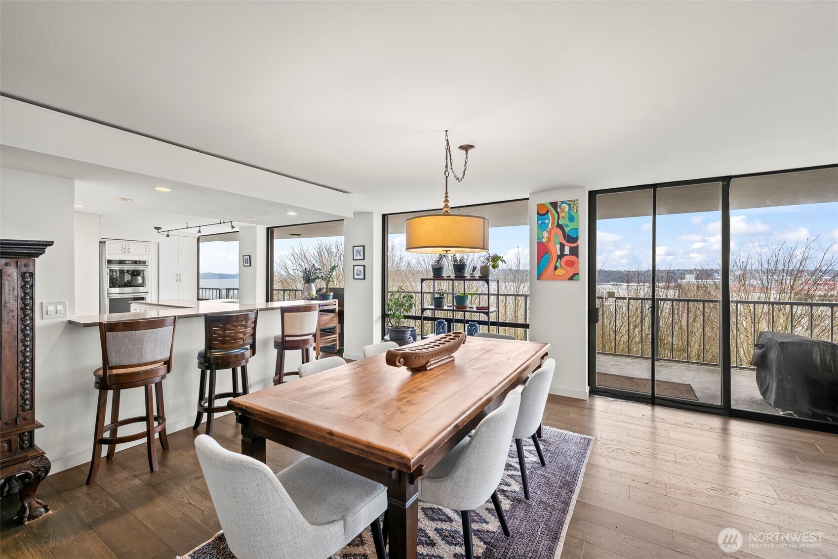 a dining room with furniture a chandelier and wooden floor