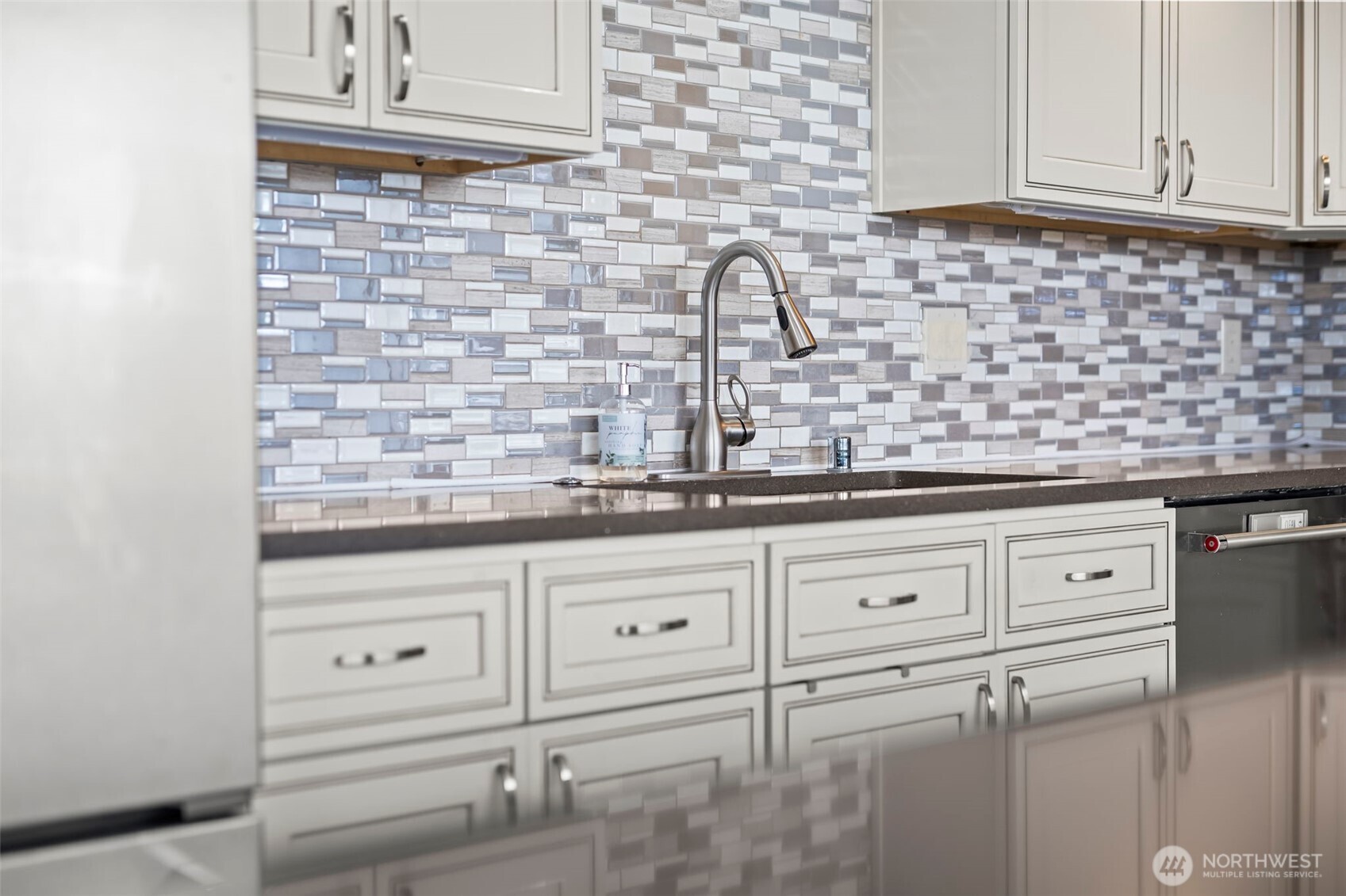 1 North Stadium Way, Unit 2 Tacoma, WA 98403 - Photo 18 of 40 a kitchen with granite countertop white cabinets and white appliances