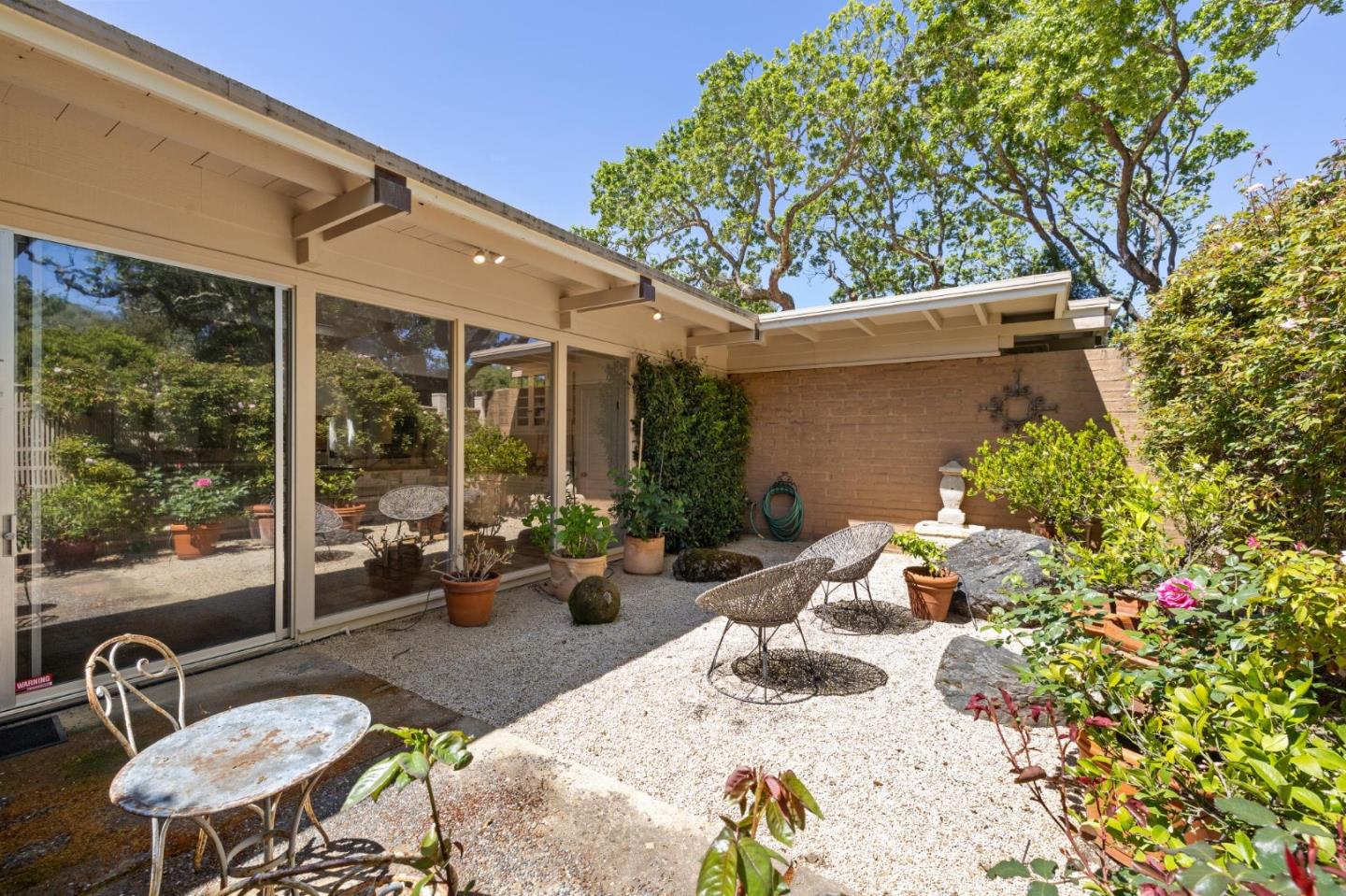 19 Ring Lane Carmel Valley, CA 93924 - Photo 27 of 60 a view of a patio with table and chairs potted plants with wooden floor and fence