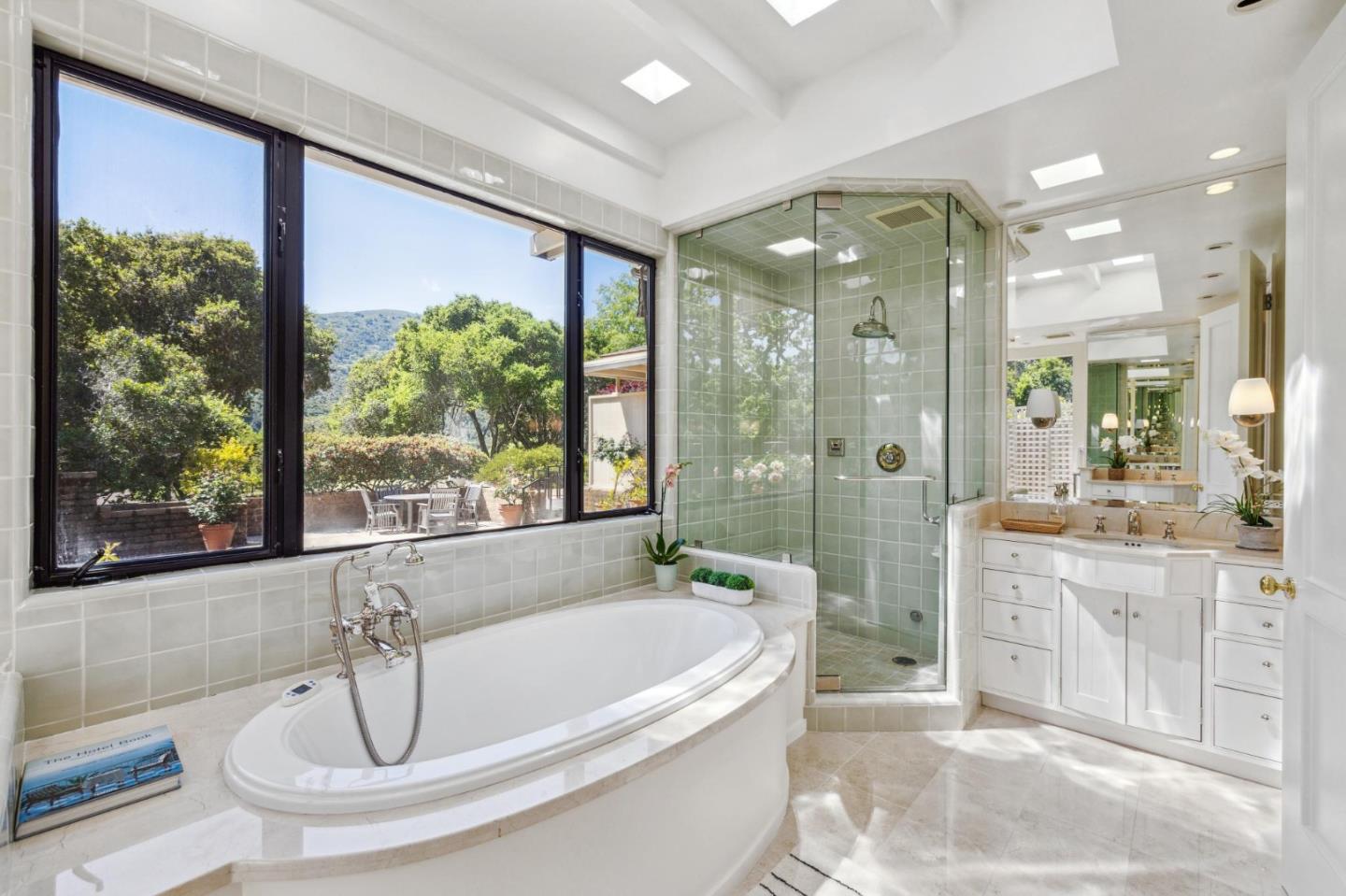 19 Ring Lane Carmel Valley, CA 93924 - Photo 43 of 60 a bathroom with a tub a sink a mirror and a shower