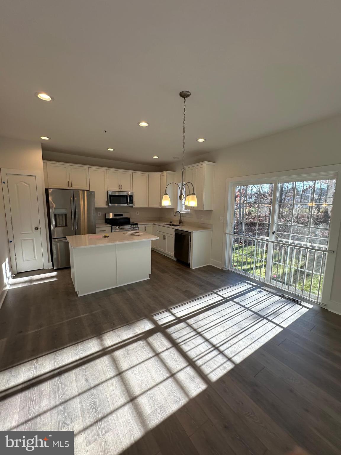 King Avenue Rosedale, MD 21237 - Photo 6 of 29 a open kitchen with stainless steel appliances granite countertop a refrigerator a sink dishwasher a stove and a microwave oven with wooden floor