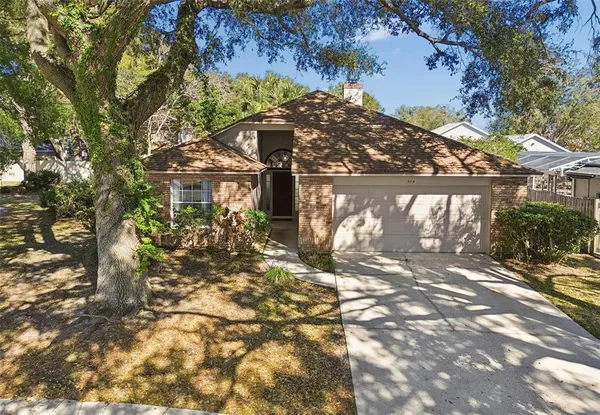 a view of a house with a tree in the background