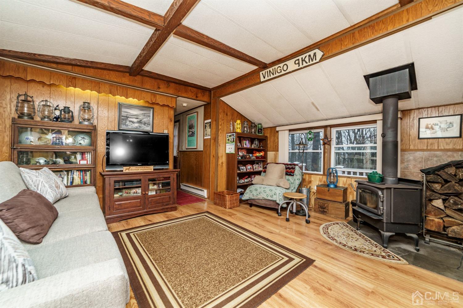 4 Timbercroft Road High Bridge, NJ 08829 - Photo 3 of 23 a living room with furniture a flat screen tv and floor to ceiling window