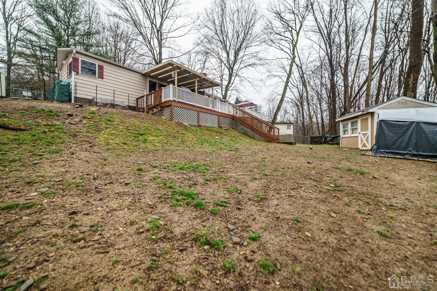 4 Timbercroft Road High Bridge, NJ 08829 - Photo 22 of 23 a backyard of a house with large trees