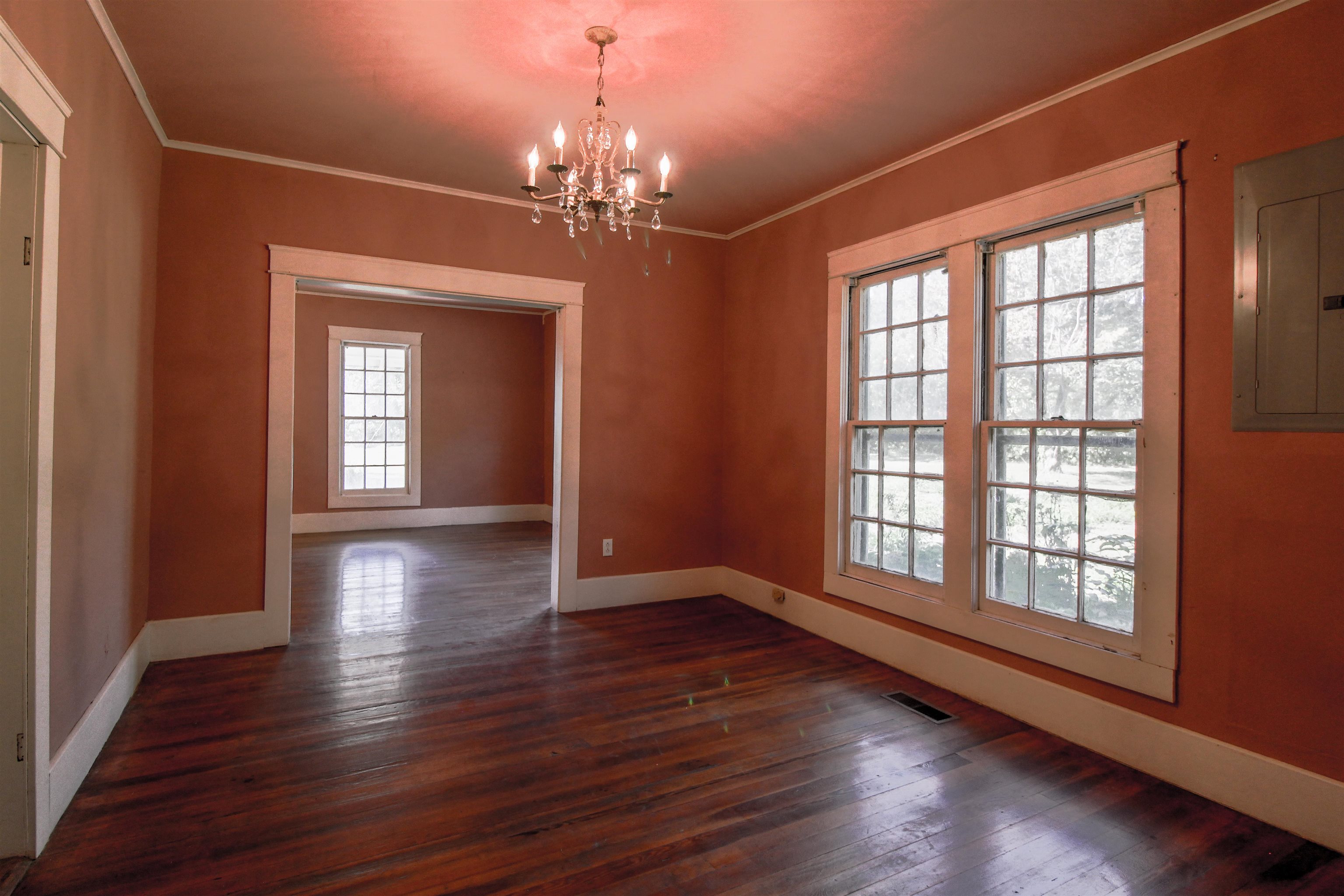 2440 Edith-Nankipoo Road Ripley, TN 38063 - Photo 4 of 27 Dining room featuring ornamental molding, a brick fireplace, original hardwood floors , and a chandelier and crown molding.