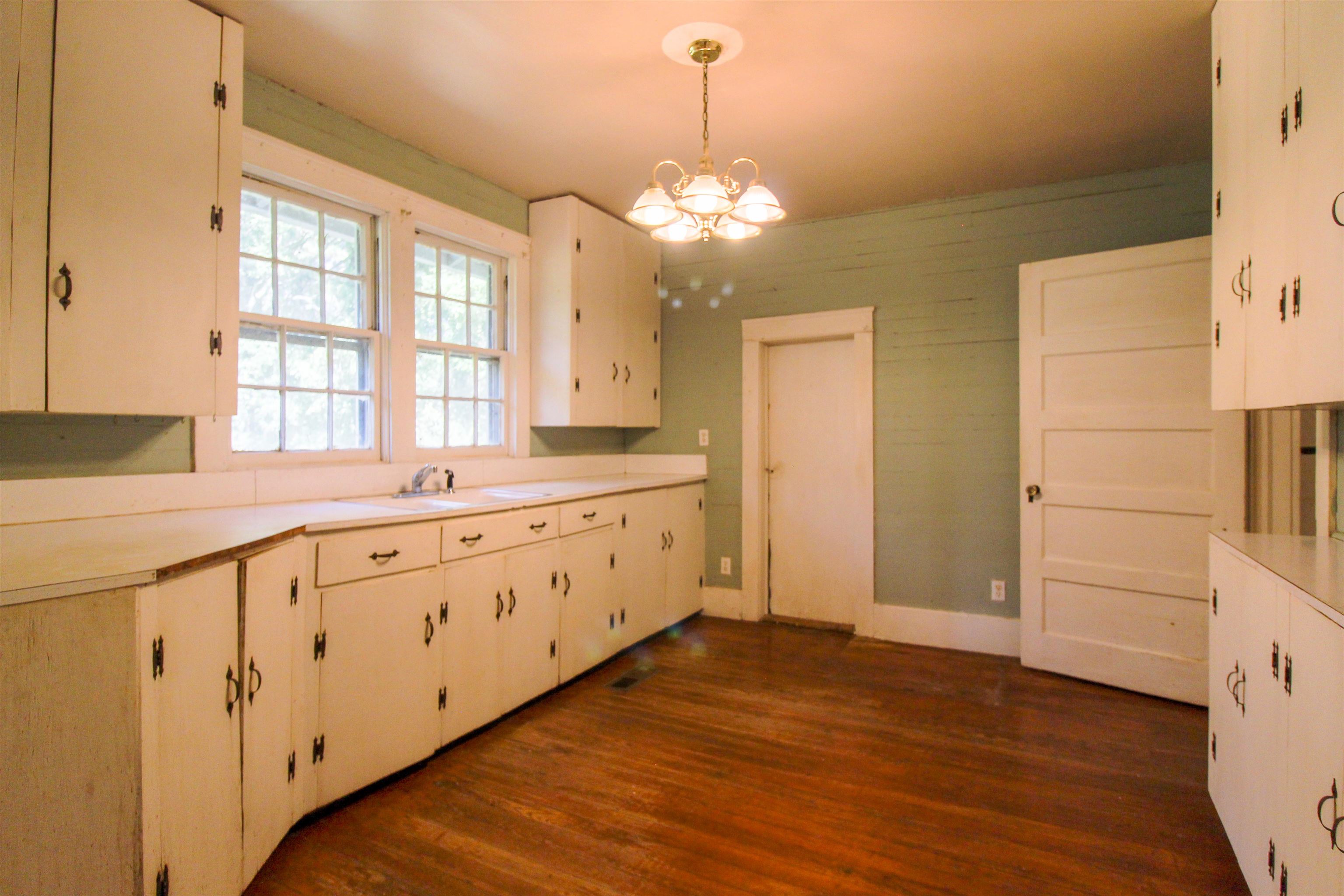 2440 Edith-Nankipoo Road Ripley, TN 38063 - Photo 6 of 27 Kitchen featuring light countertops, pendant lighting, dark wood-style flooring, and a chandelier
