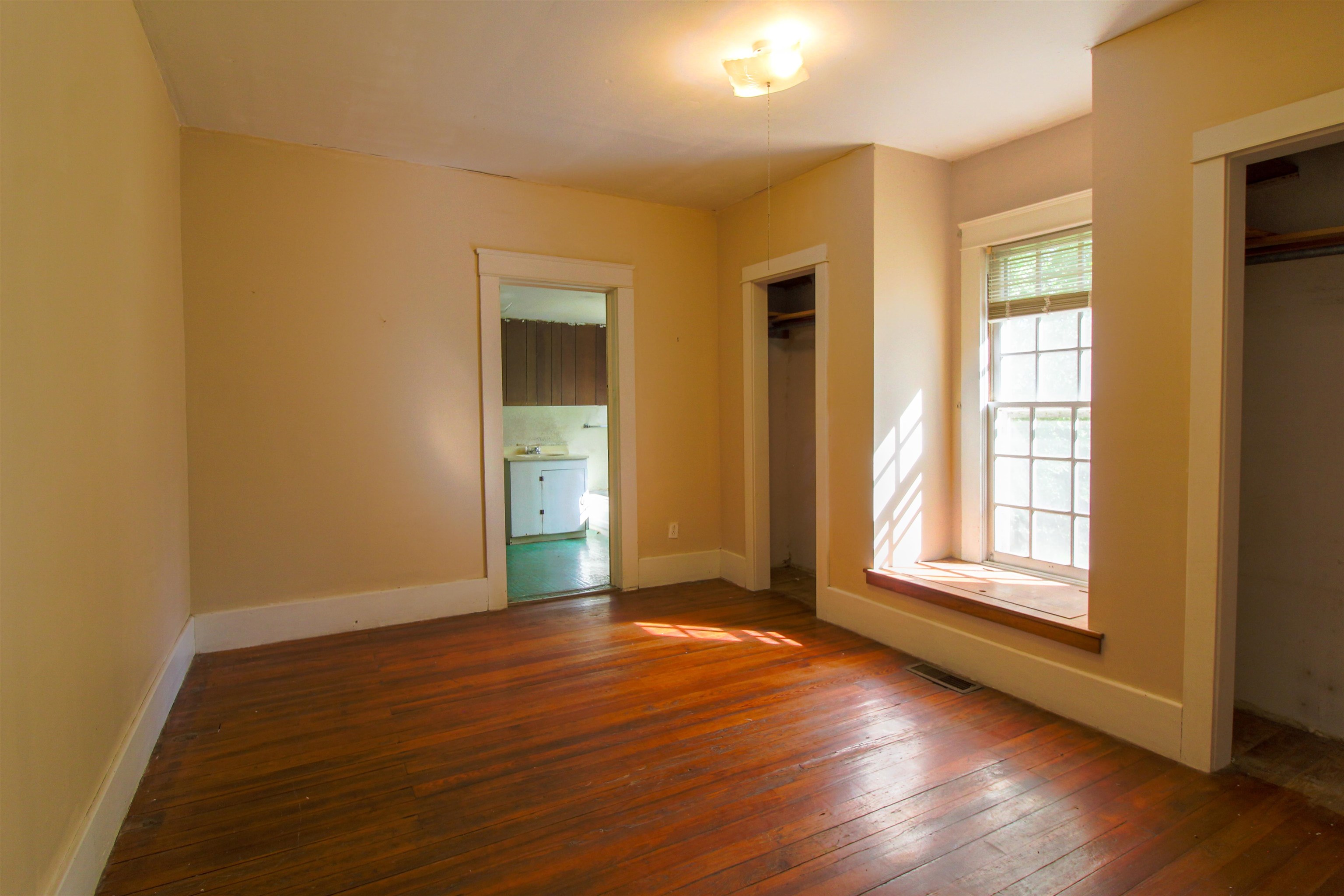 2440 Edith-Nankipoo Road Ripley, TN 38063 - Photo 10 of 27 Bedroom featuring original hardwood floors and two closets