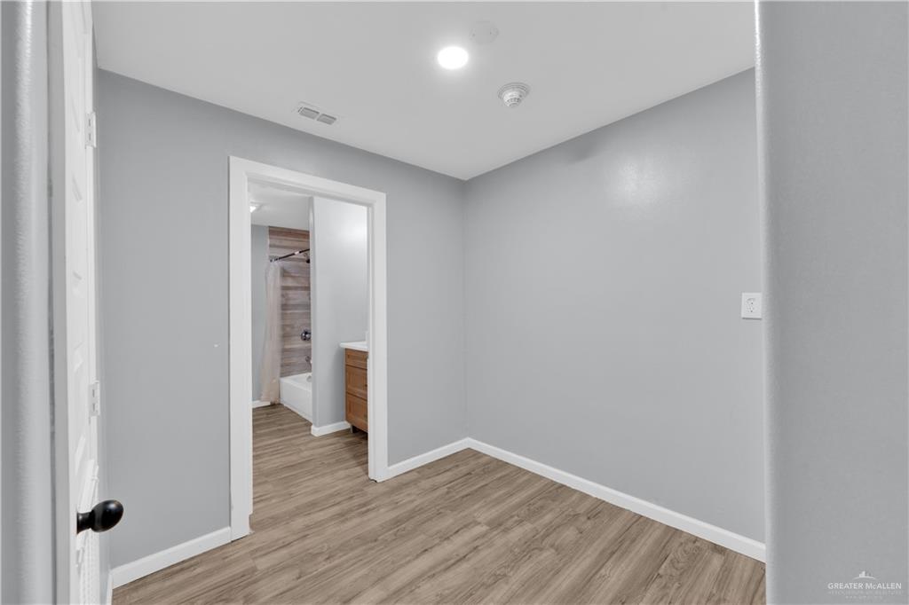 405 East Guerra Street Rio Grande City, TX 78582 - Photo 11 of 33 Unfurnished room featuring light wood-type flooring and baseboards