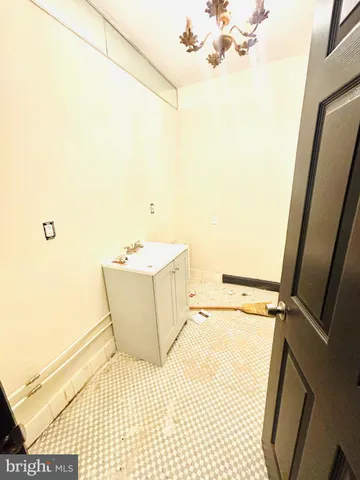 a bathroom with a sink a toilet a mirror and shower