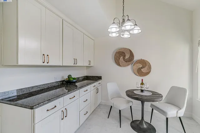 a kitchen with furniture and chandelier