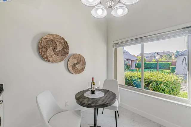 a view of a room with a table and chairs