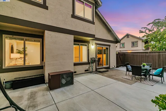 a view of a house with backyard and sitting area
