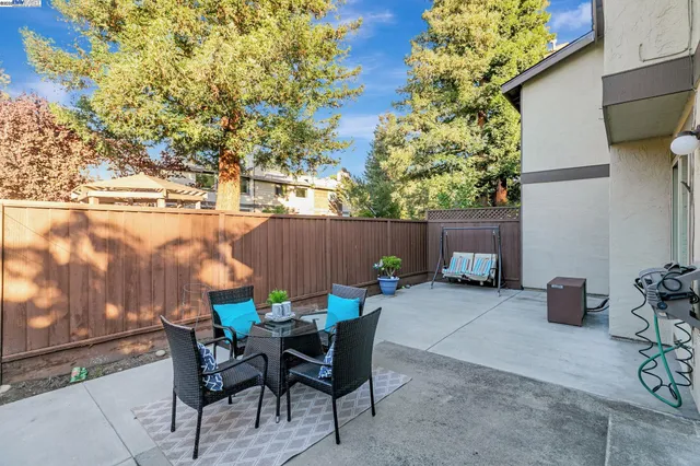 a view of a house with backyard and sitting area