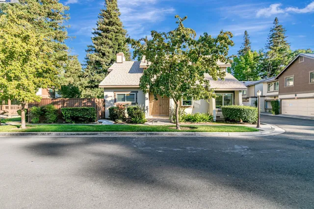 front view of a house with a yard and a street