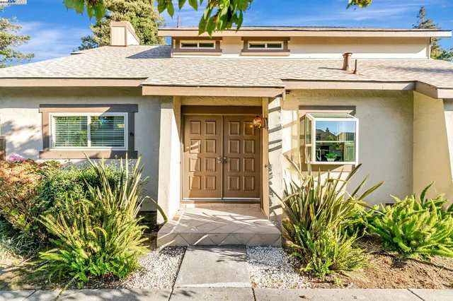 a front view of a house with a garden