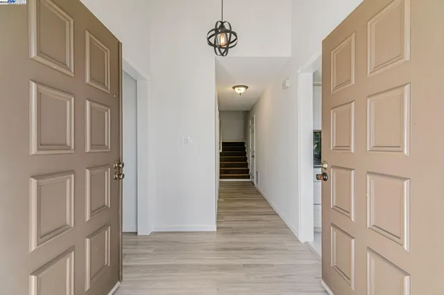 a view of a livingroom with wooden floor and stairs