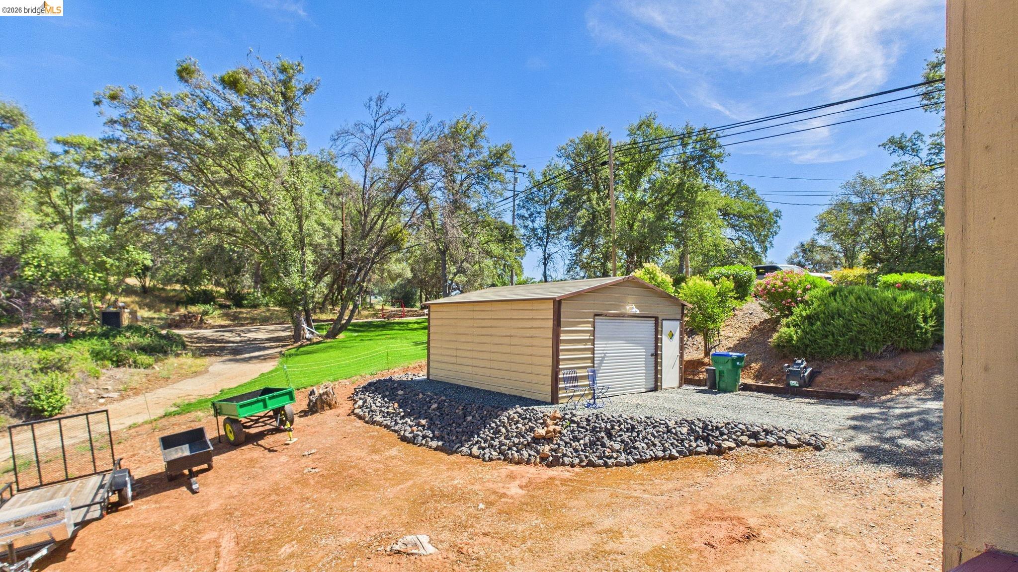 11858 Campo Seco Road Sonora, CA 95370 - Photo 39 of 45 Detached utility building with roll-up garage door and an additional pedestrian door