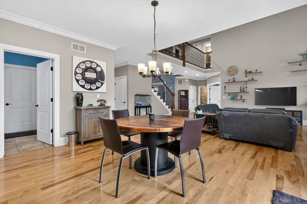 a spacious bedroom with a bed and a chandelier