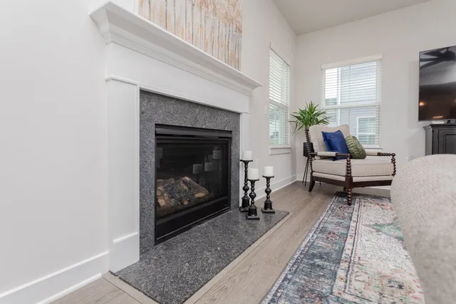 a kitchen with stainless steel appliances kitchen island granite countertop a dining table chairs and white cabinets