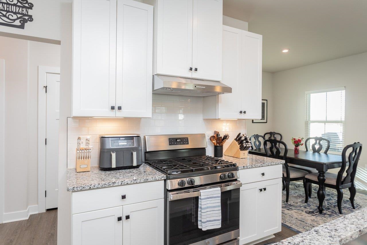 2754 Rdg Hvn Drive Harrisonburg, VA 22801 - Photo 23 of 64 a kitchen with granite countertop a sink stove and cabinets