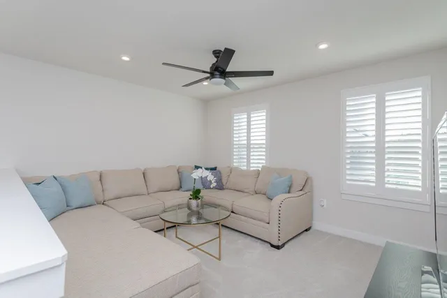 a bedroom with a bed a couch and a potted plant