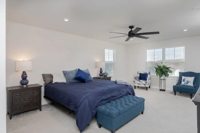 a spacious bedroom with a bed a window and closet