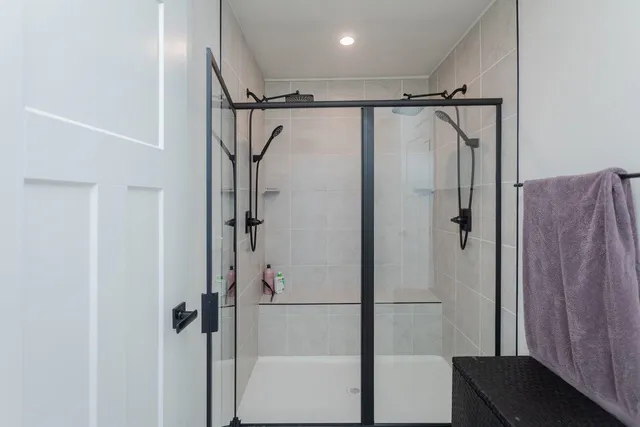 a bedroom with a bed and a lamp on the dresser