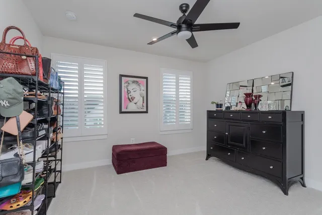 a patio with table and chairs and potted plants