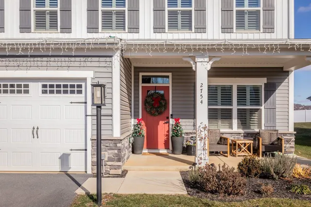 a front view of a house with a yard table and chairs