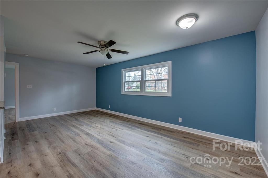 1048 Avondale Road, Unit 14 Lowell, NC 28098 - Photo 4 of 11 an empty room with wooden floor and windows